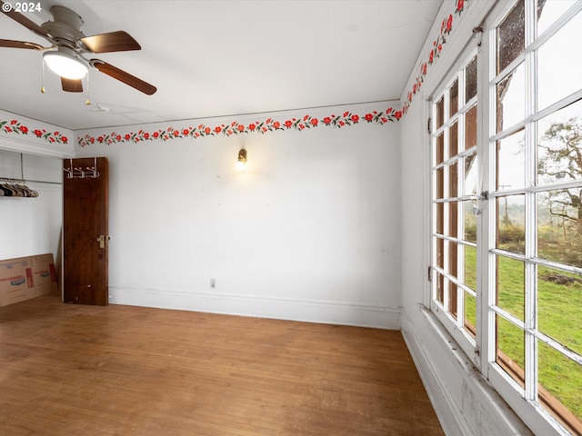 spare room with hardwood / wood-style flooring and ceiling fan