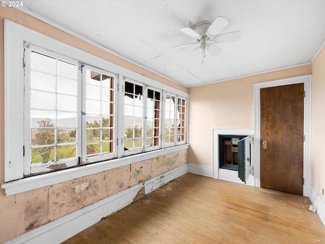 sunroom / solarium with ceiling fan and a fireplace