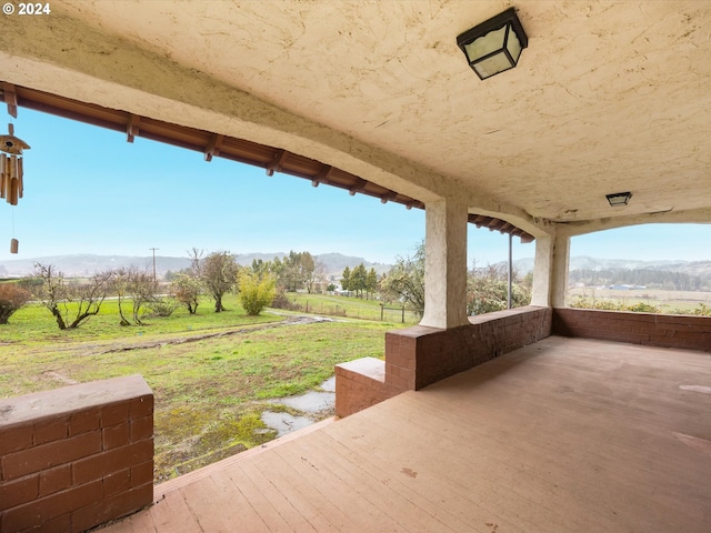 view of patio / terrace featuring a mountain view and a rural view