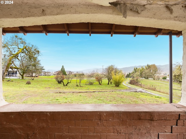 view of yard with a rural view and a mountain view