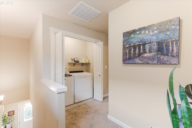 2839 25th Ave, Forest Grove, OR 97116 - corridor with washing machine and clothes dryer, light colored carpet, and baseboards