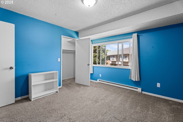 2062 NE Hogan Dr, Gresham, OR 97030 - unfurnished bedroom featuring a baseboard heating unit, carpet, a textured ceiling, and a closet