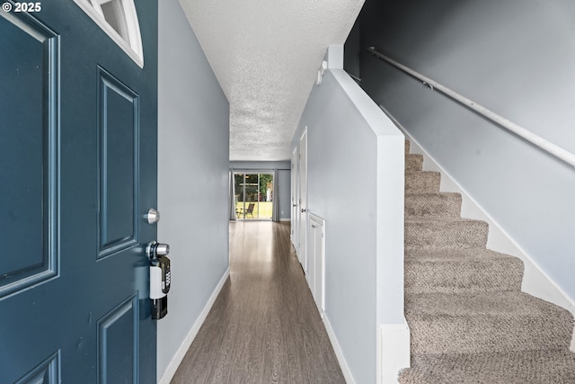 2062 NE Hogan Dr, Gresham, OR 97030 - entrance foyer featuring a textured ceiling, dark wood-type flooring, and stairway