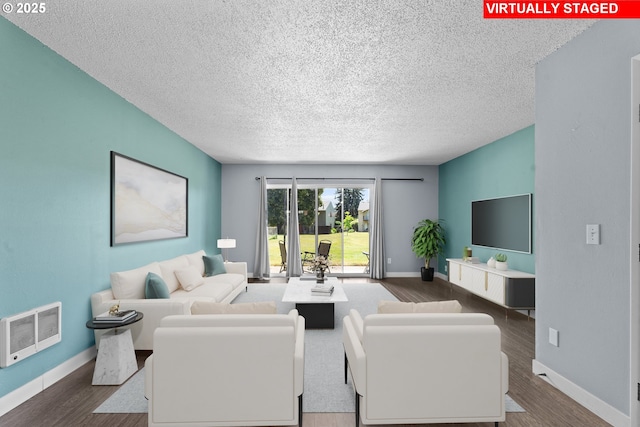 2062 NE Hogan Dr, Gresham, OR 97030 - living area with a textured ceiling, wood finished floors, and heating unit