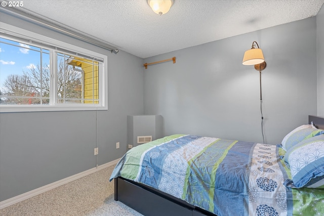 carpeted bedroom featuring a textured ceiling