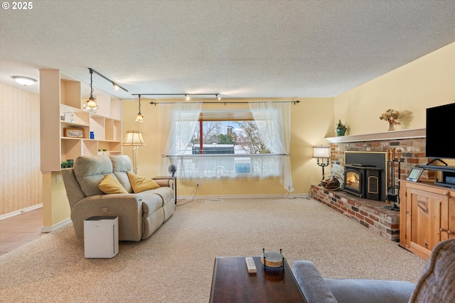 carpeted living room featuring track lighting and a textured ceiling