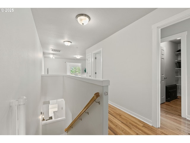 interior space with visible vents, baseboards, and wood finished floors