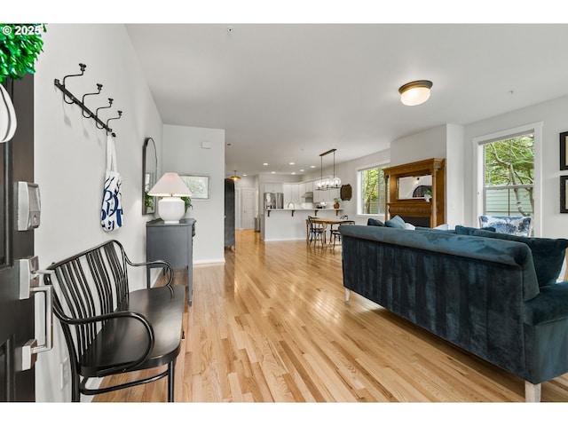 living room with light wood-type flooring and recessed lighting