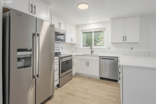 2817 Applewood Ln, Eugene, OR 97408 - kitchen featuring stainless steel appliances, white cabinetry, light wood-style flooring, light countertops, and recessed lighting
