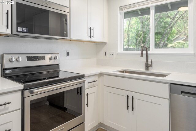 2817 Applewood Ln, Eugene, OR 97408 - kitchen with stainless steel appliances, white cabinetry, and light countertops