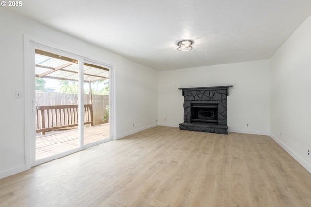 2817 Applewood Ln, Eugene, OR 97408 - unfurnished living room with light wood-type flooring and a stone fireplace