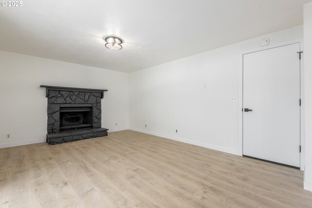 2817 Applewood Ln, Eugene, OR 97408 - unfurnished living room with light wood finished floors and a stone fireplace