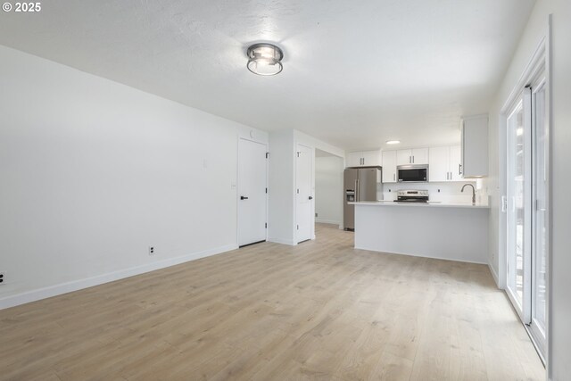 2817 Applewood Ln, Eugene, OR 97408 - unfurnished living room with light wood-style flooring and baseboards