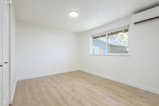 2817 Applewood Ln, Eugene, OR 97408 - empty room with an AC wall unit and light wood-style flooring