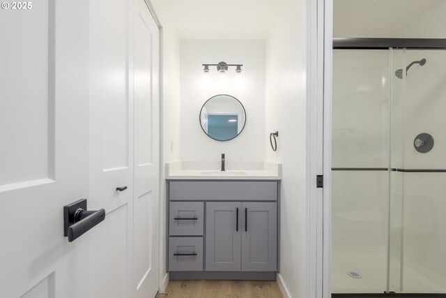 2817 Applewood Ln, Eugene, OR 97408 - bathroom featuring a shower stall, vanity, and wood finished floors