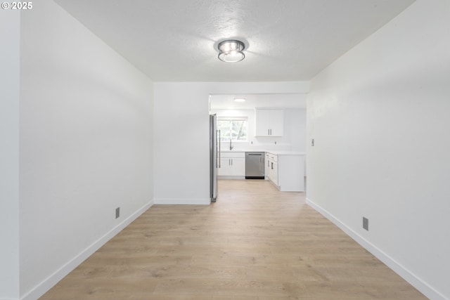 2817 Applewood Ln, Eugene, OR 97408 - unfurnished living room with light wood-style floors and a textured ceiling