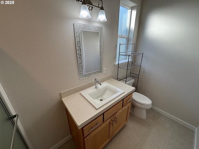 bathroom featuring toilet and vanity