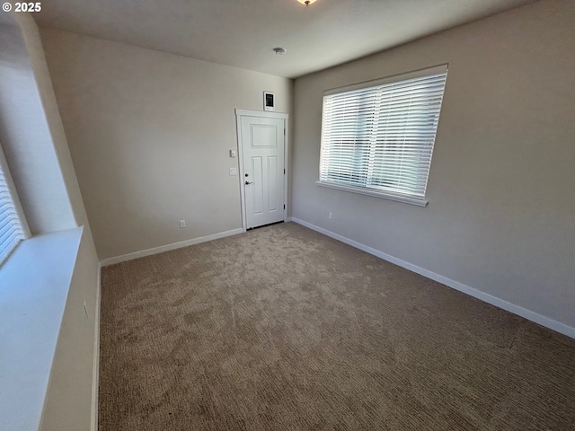 unfurnished room featuring light colored carpet