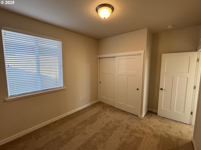 unfurnished bedroom with carpet and a closet