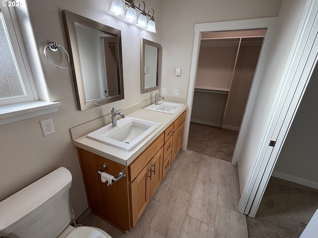 bathroom featuring toilet, vanity, and hardwood / wood-style floors