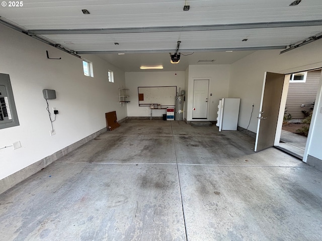 garage featuring electric water heater and a garage door opener