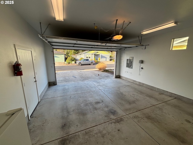 garage with electric panel and a garage door opener