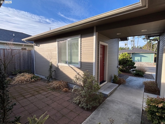 view of exterior entry with a patio