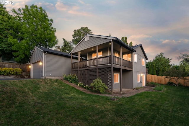 6902 SW Taylors Ferry Rd, Portland, OR 97223 - back of house at dusk with an outbuilding and an attached garage