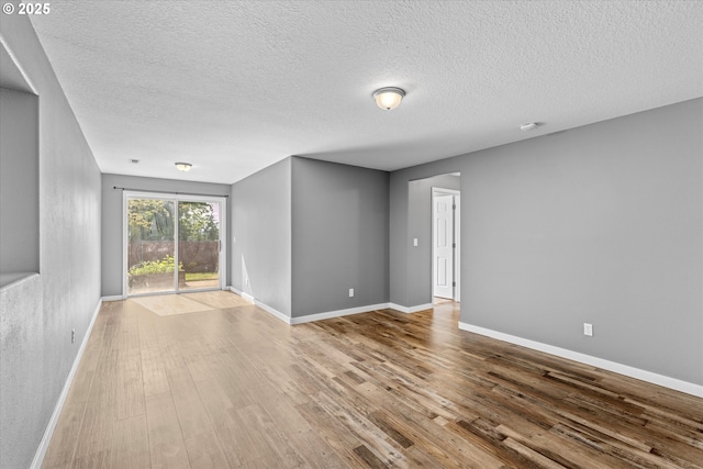 6902 SW Taylors Ferry Rd, Portland, OR 97223 - spare room with a textured ceiling and wood finished floors