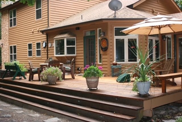 back of house featuring a deck