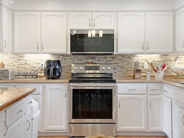 kitchen featuring white cabinets, backsplash, and stainless steel appliances