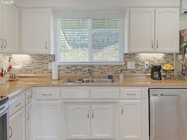 kitchen with a sink, stainless steel appliances, plenty of natural light, and white cabinetry