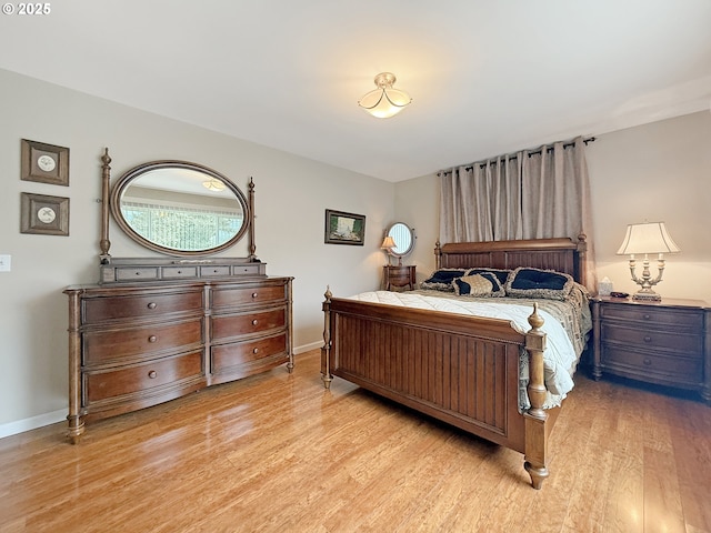 bedroom featuring light wood-type flooring and baseboards