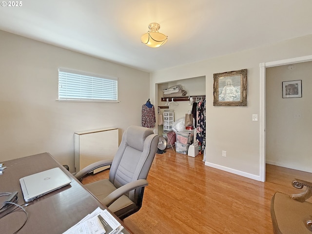 office with light wood-style flooring and baseboards