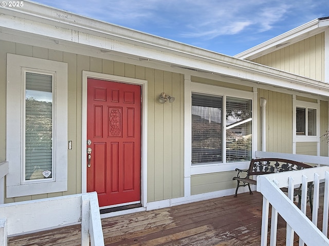 view of exterior entry featuring covered porch