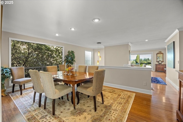 dining area featuring recessed lighting, baseboards, crown molding, and light wood finished floors