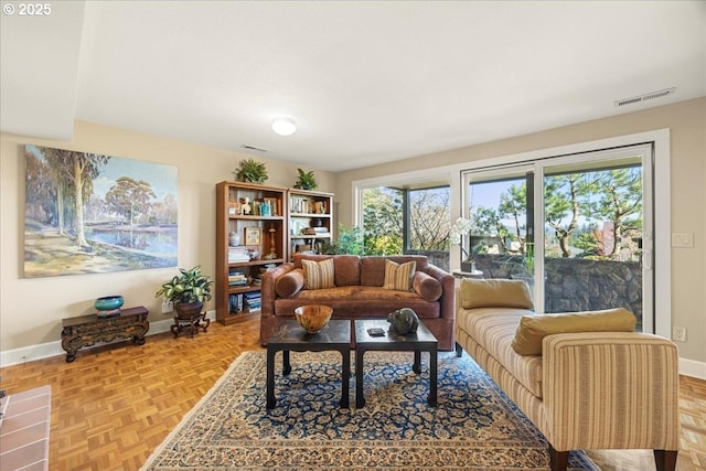 living room featuring visible vents and baseboards