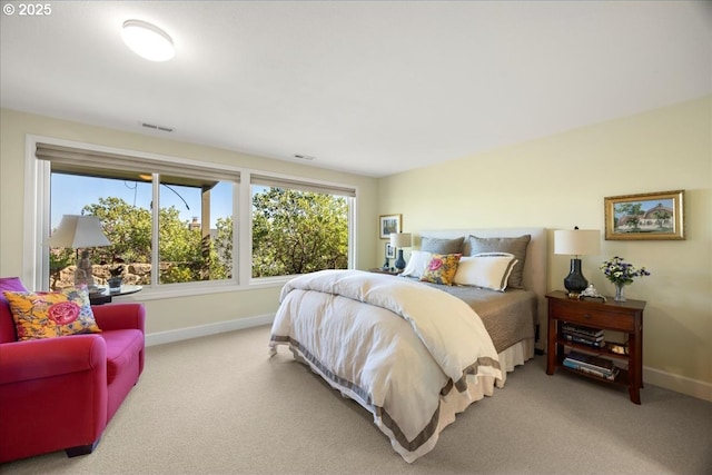 bedroom featuring visible vents, baseboards, and carpet