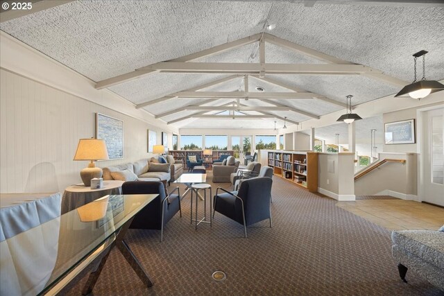 living room featuring baseboards, a textured ceiling, and vaulted ceiling with beams