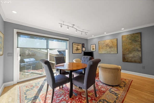 dining room featuring recessed lighting, baseboards, light wood finished floors, and ornamental molding