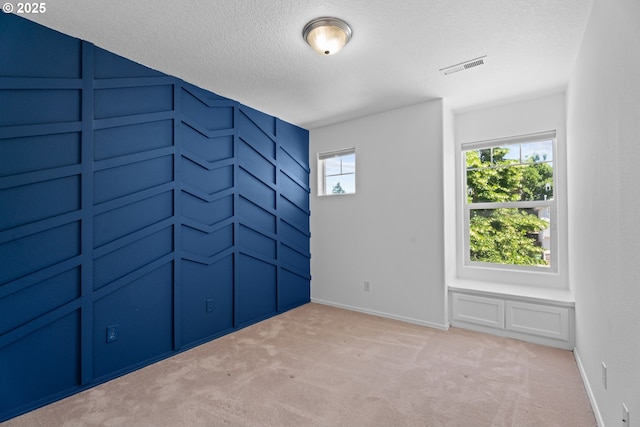 1938 27th Ave, Forest Grove, OR 97116 - empty room with plenty of natural light, a textured ceiling, light colored carpet, and baseboards