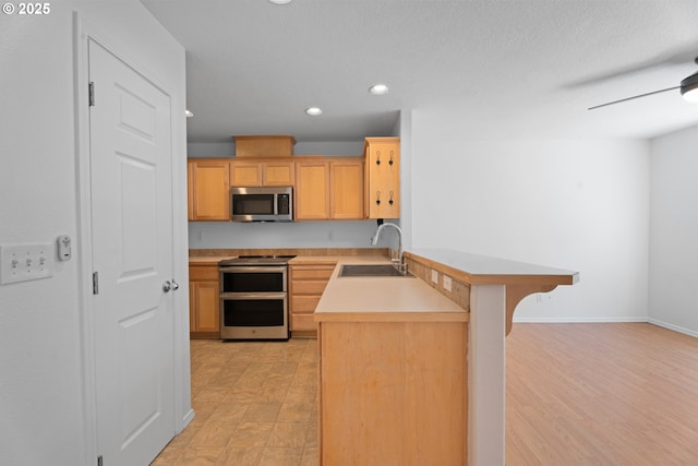 1938 27th Ave, Forest Grove, OR 97116 - kitchen with stainless steel appliances, a sink, a peninsula, recessed lighting, and light countertops