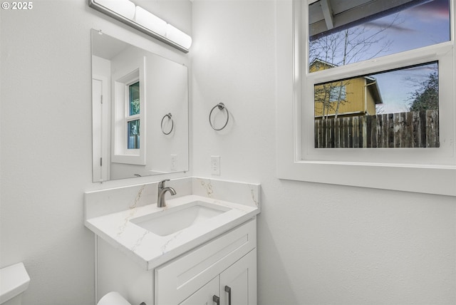 bathroom featuring toilet and vanity