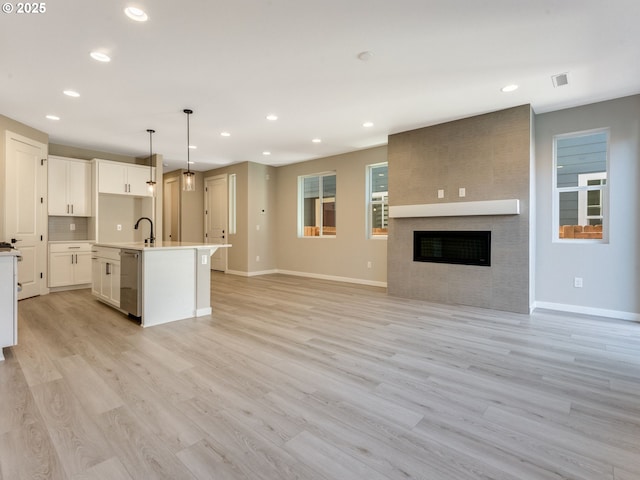 702 NW 178th Way, Ridgefield, WA 98642 - kitchen featuring dishwasher, baseboards, white cabinetry, open floor plan, and recessed lighting