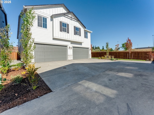 702 NW 178th Way, Ridgefield, WA 98642 - view of front of property featuring board and batten siding, concrete driveway, a garage, and fence