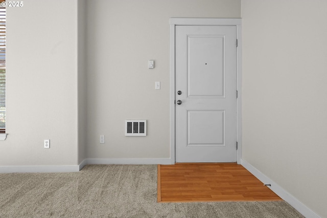 doorway with light colored carpet