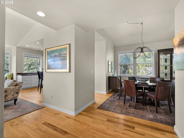 dining room with light wood-style floors, recessed lighting, baseboards, and vaulted ceiling
