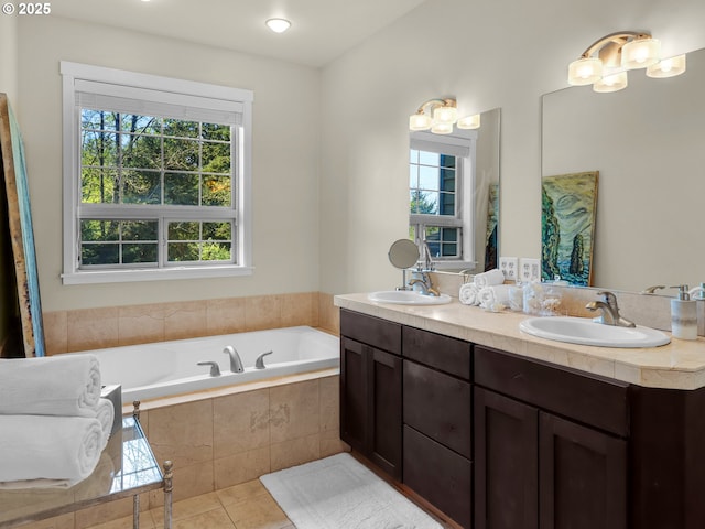 bathroom with a wealth of natural light, a sink, and a bath