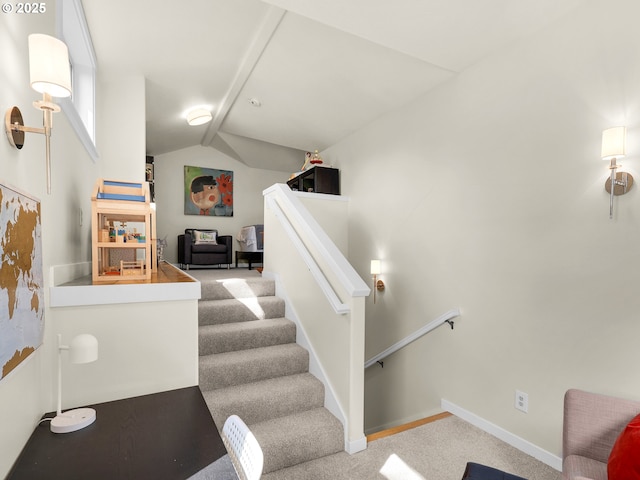 stairway with carpet floors, baseboards, and lofted ceiling