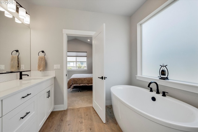 1332 SE 14th Ave, Canby, OR 97013 - full bath with wood finished floors, vanity, a freestanding bath, ensuite bath, and baseboards